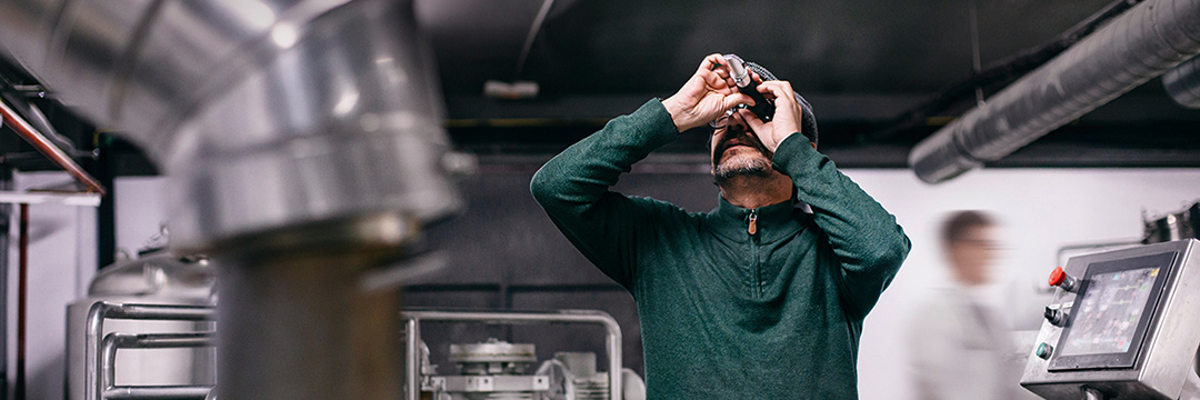 a man in a production hall, is controlling something