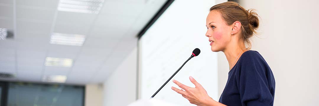 Woman speaks into microphone