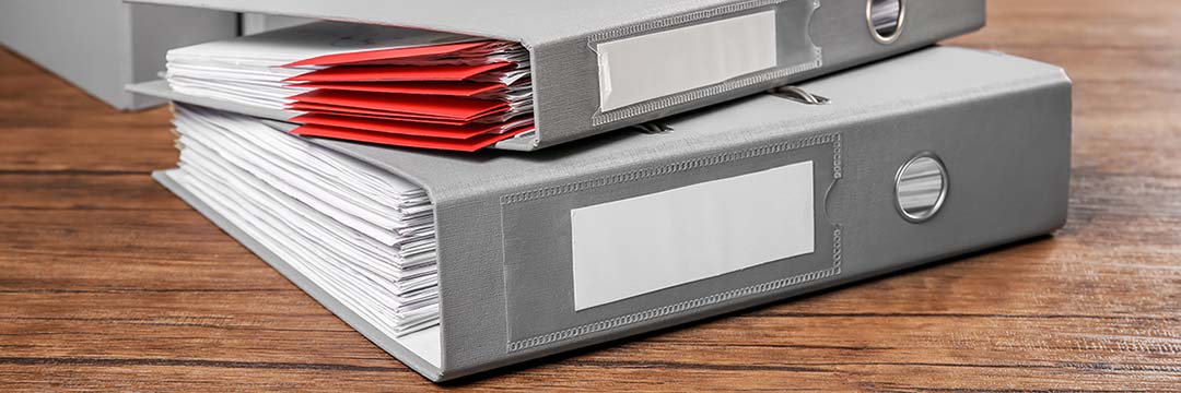Folders with documents on table in archive