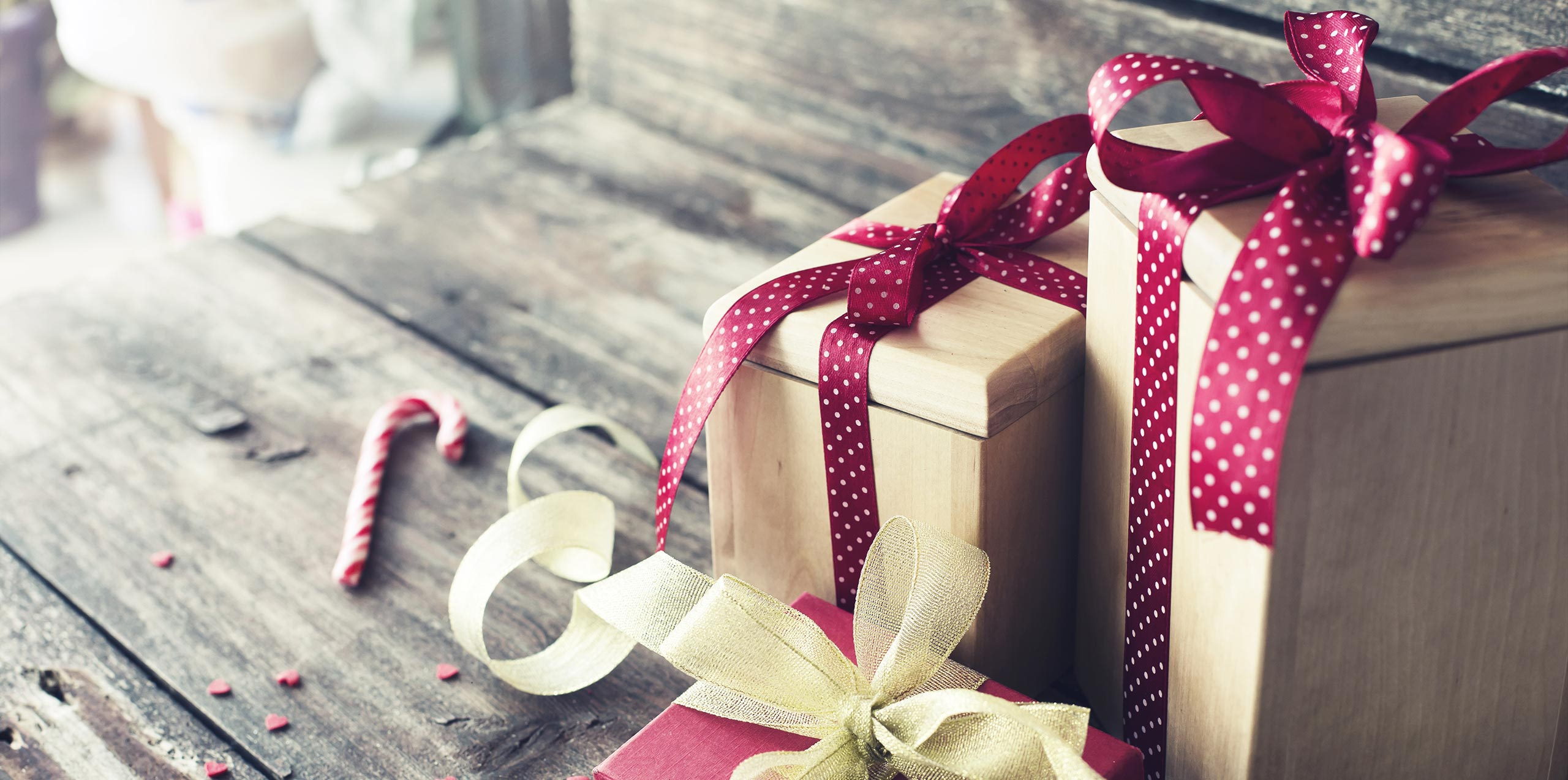 Christmas packages with red ribbons on a table