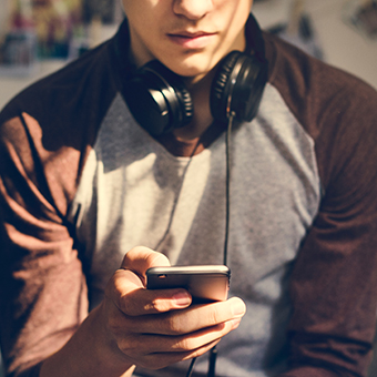 A young man looking at his smartphone
